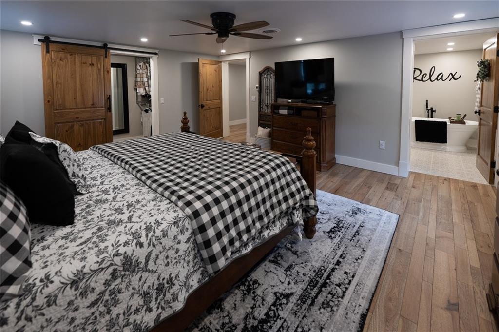 304 Ellermeyer Road Walston, PA 15781 - Photo 22 of 50 a large bedroom with a bed and a flat tv screen on dresser