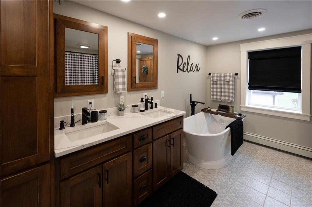 304 Ellermeyer Road Walston, PA 15781 - Photo 23 of 50 a spacious bathroom with a double vanity sink a mirror and a bathtub