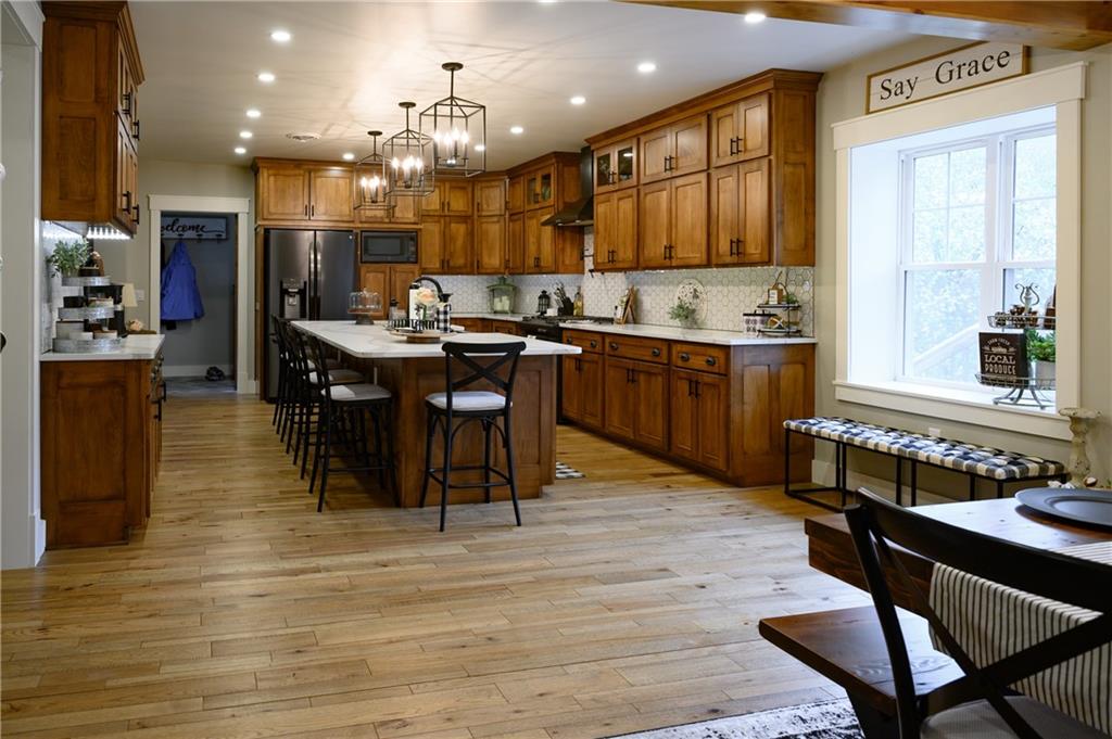 304 Ellermeyer Road Walston, PA 15781 - Photo 3 of 50 a kitchen with stainless steel appliances granite countertop a table chairs sink and cabinets