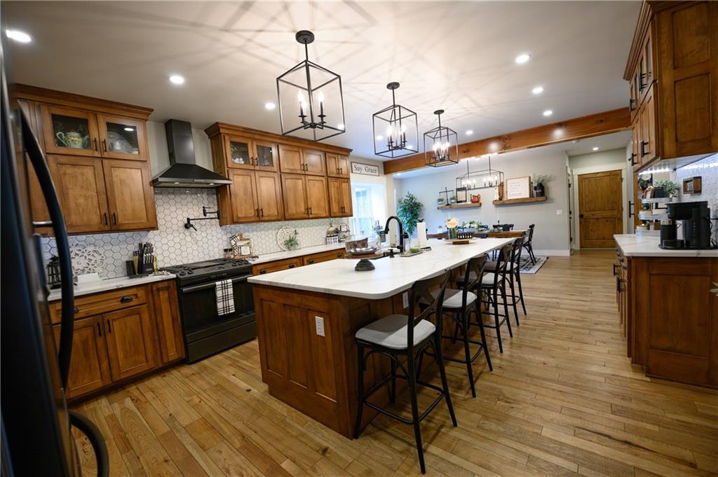 304 Ellermeyer Road Walston, PA 15781 - Photo 4 of 50 a kitchen with stainless steel appliances granite countertop a sink a stove and a wooden floors