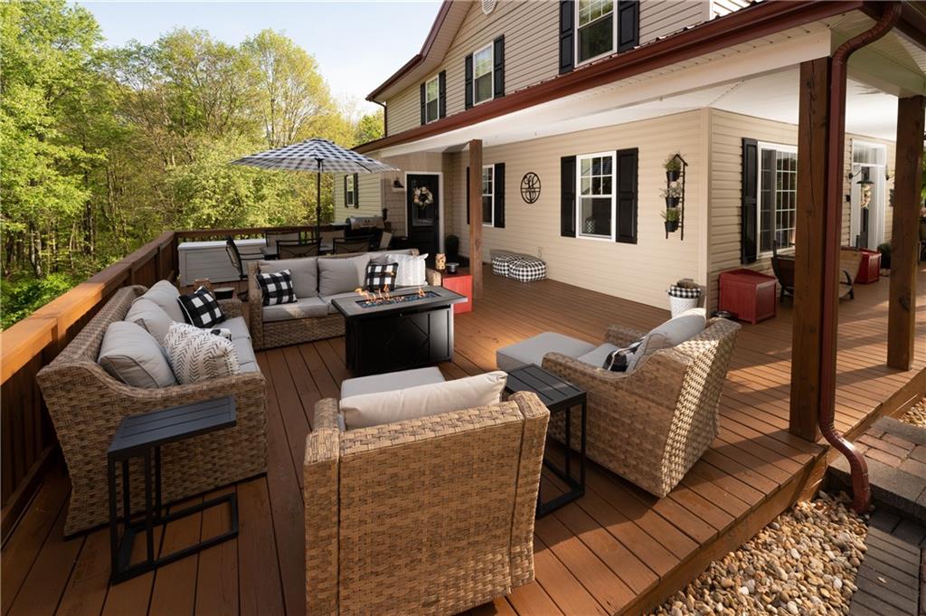 304 Ellermeyer Road Walston, PA 15781 - Photo 42 of 50 a view of a patio with couches chairs and wooden floor