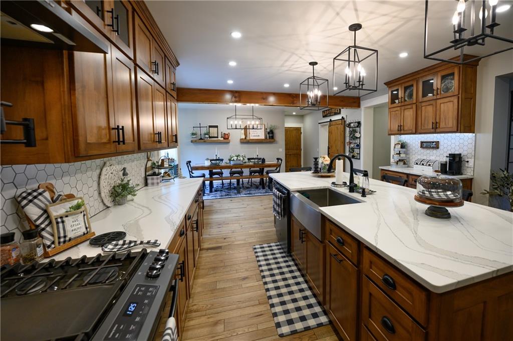 304 Ellermeyer Road Walston, PA 15781 - Photo 5 of 50 a kitchen with stainless steel appliances a stove a sink dishwasher and cabinets with wooden floor