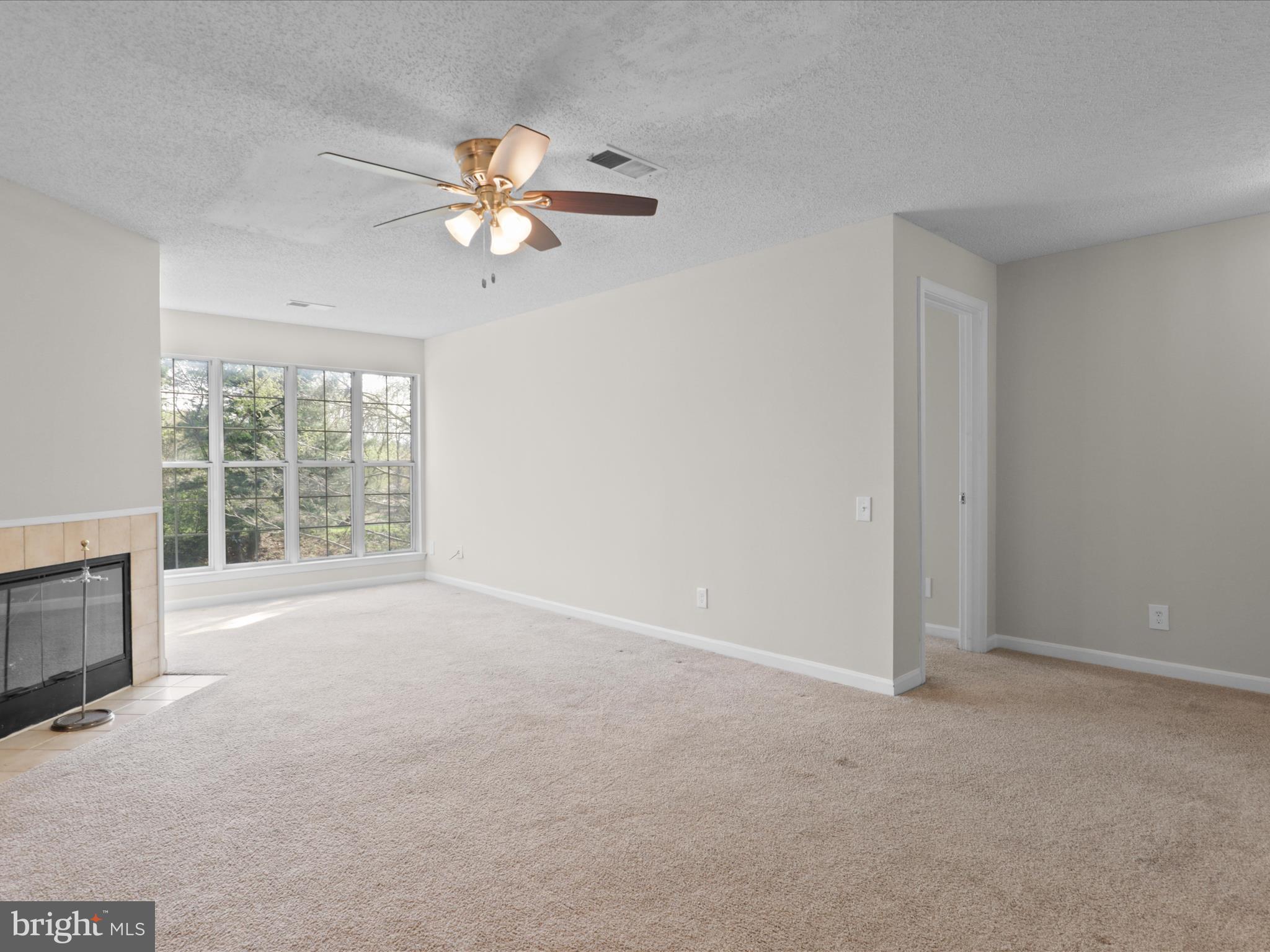 12008 Golf Ridge Court, Unit 356 Fairfax, VA 22033 - Photo 4 of 33 a view of a livingroom with a ceiling fan and window
