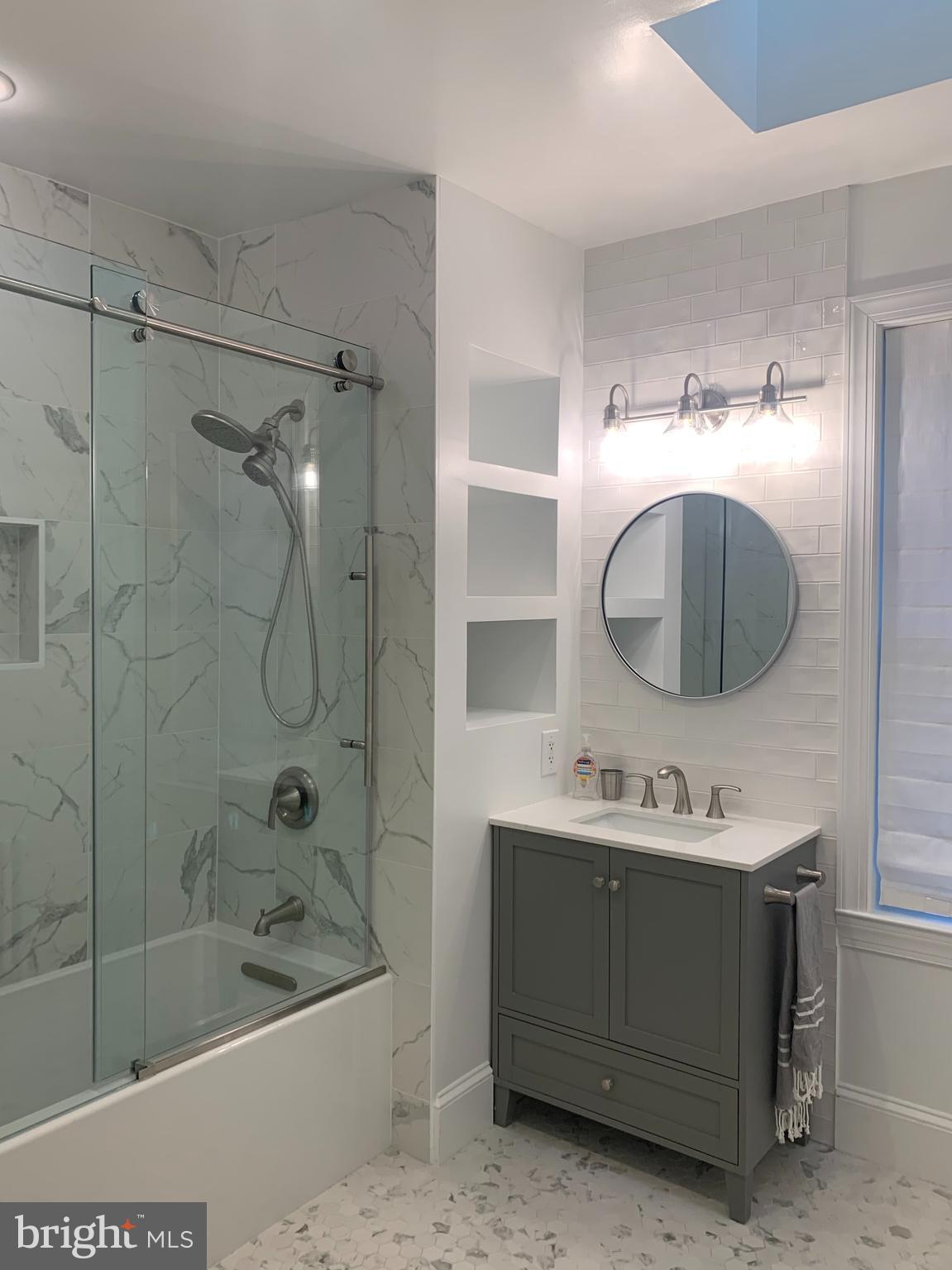 612 C Street Southeast Washington, DC 20003 - Photo 13 of 20 a bathroom with a sink mirror and bathtub