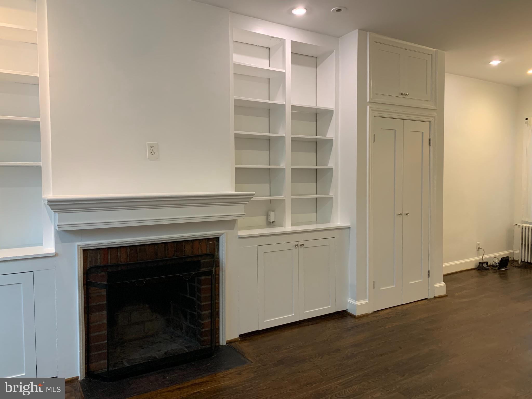 612 C Street Southeast Washington, DC 20003 - Photo 3 of 20 a living room with a fireplace cabinet and a fireplace
