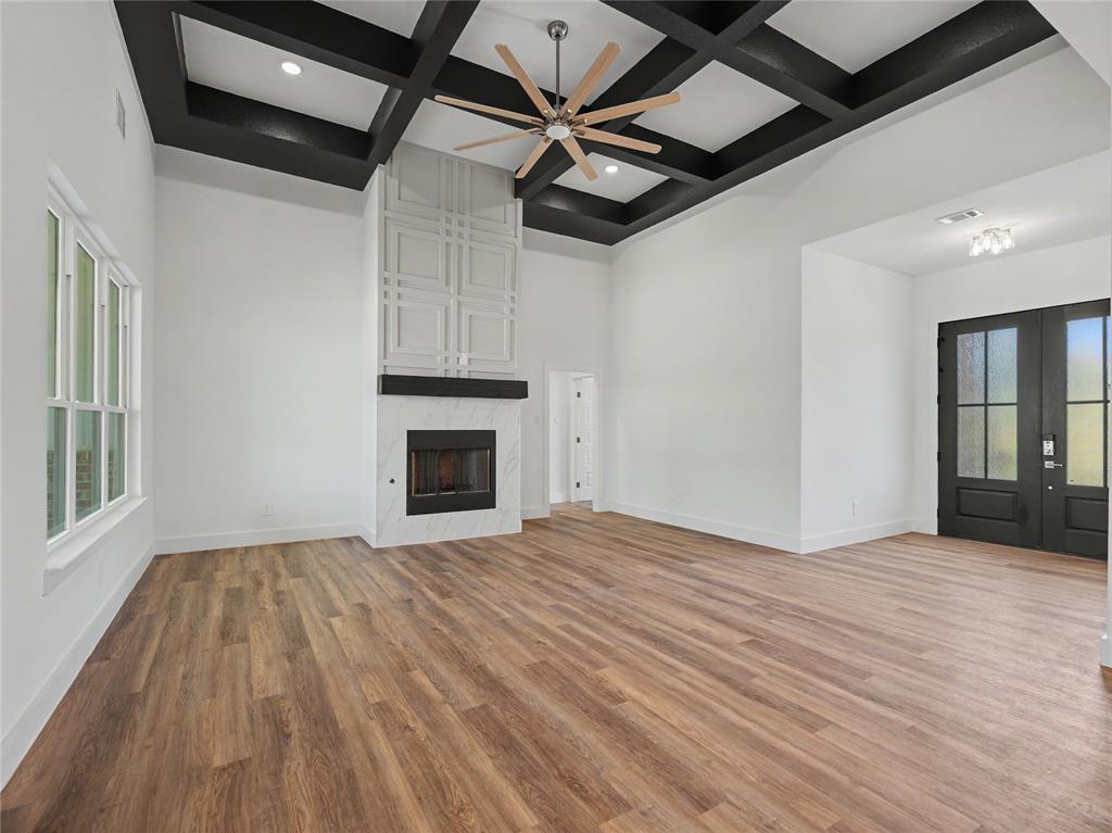 328 Slimp Bluff Azle, TX 76020 - Photo 5 of 30 Expansive living area with a coffered ceiling and a large ceiling fan