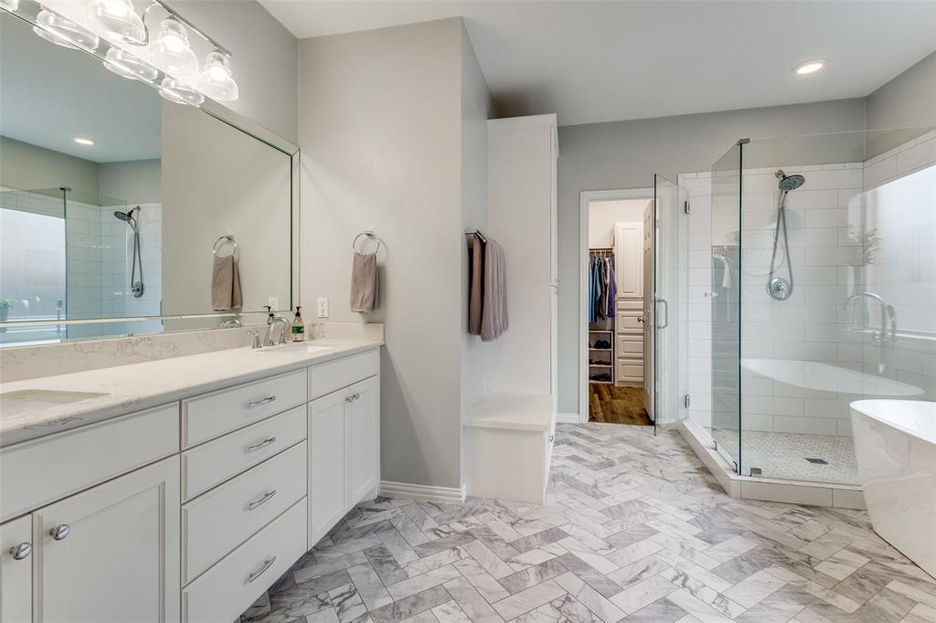 1524 Rustic Timbers Lane Flower Mound, TX 75028 - Photo 14 of 28 a spacious bathroom with a shower sink and mirror
