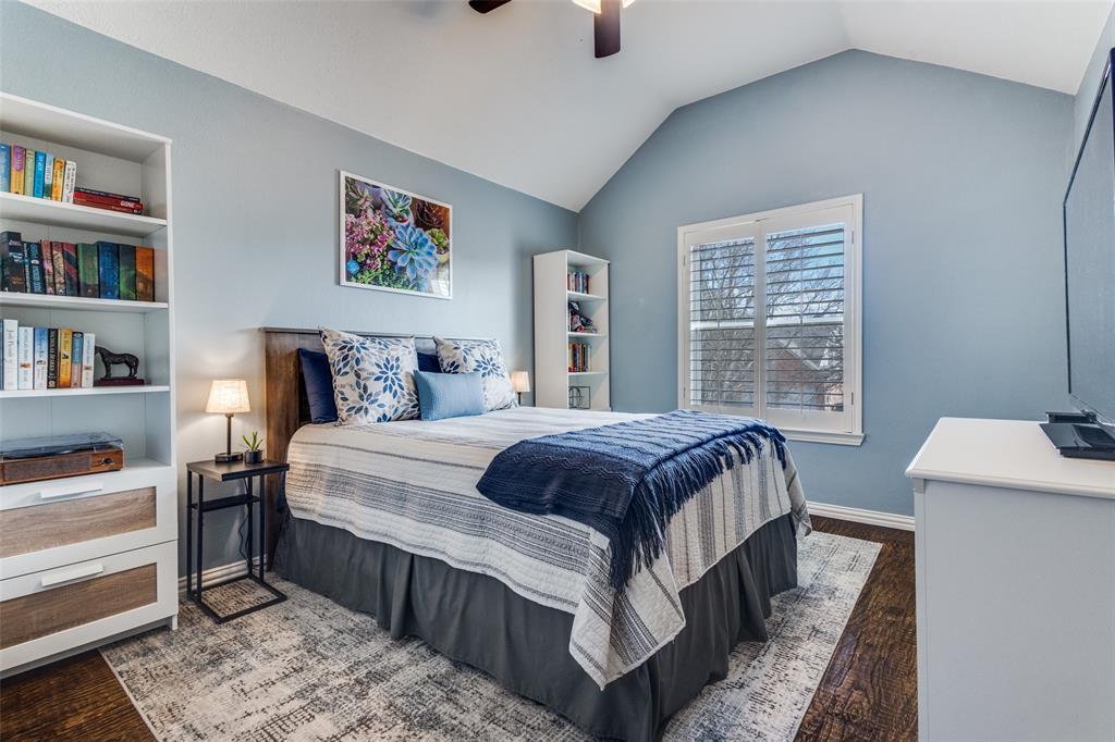 1524 Rustic Timbers Lane Flower Mound, TX 75028 - Photo 17 of 28 a bedroom with bed and a book shelf