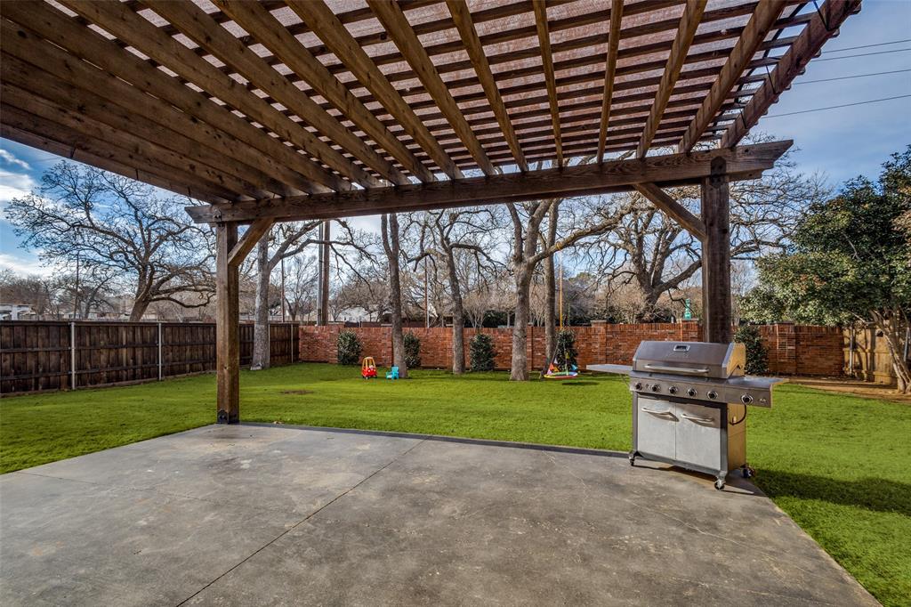 1524 Rustic Timbers Lane Flower Mound, TX 75028 - Photo 21 of 28 a view of a backyard with wooden fence and a large tree