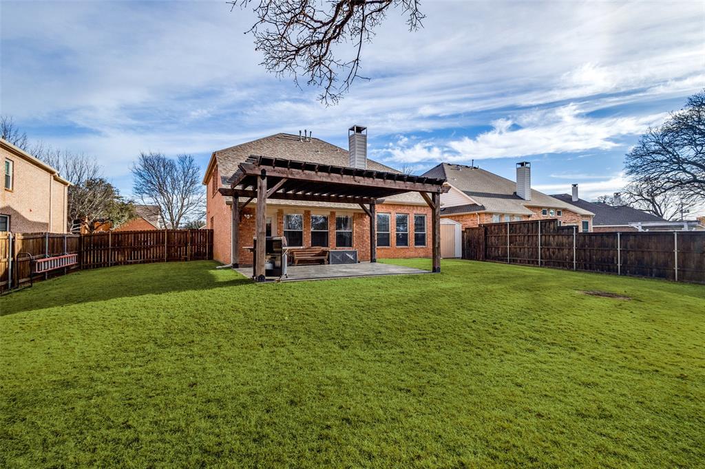 1524 Rustic Timbers Lane Flower Mound, TX 75028 - Photo 23 of 28 a front view of a house with a garden