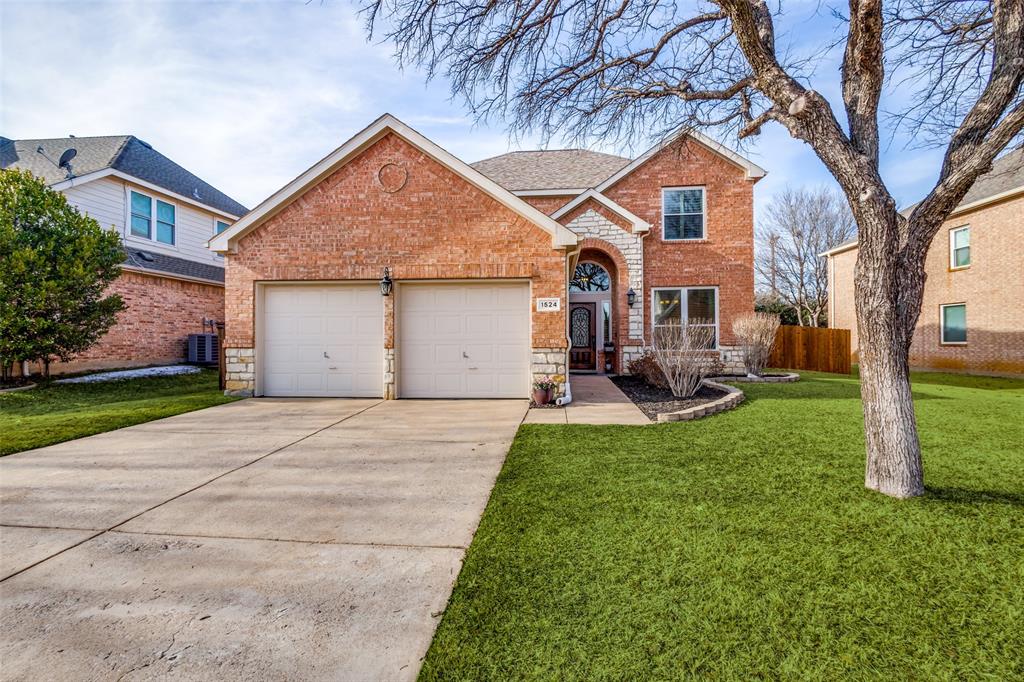 1524 Rustic Timbers Lane Flower Mound, TX 75028 - Photo 3 of 28 a front view of a house with a yard and trees