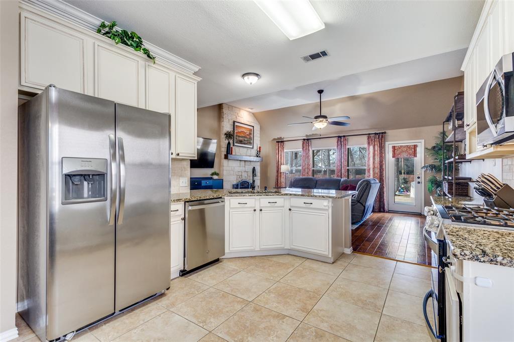 1524 Rustic Timbers Lane Flower Mound, TX 75028 - Photo 7 of 28 a kitchen with refrigerator and cabinets