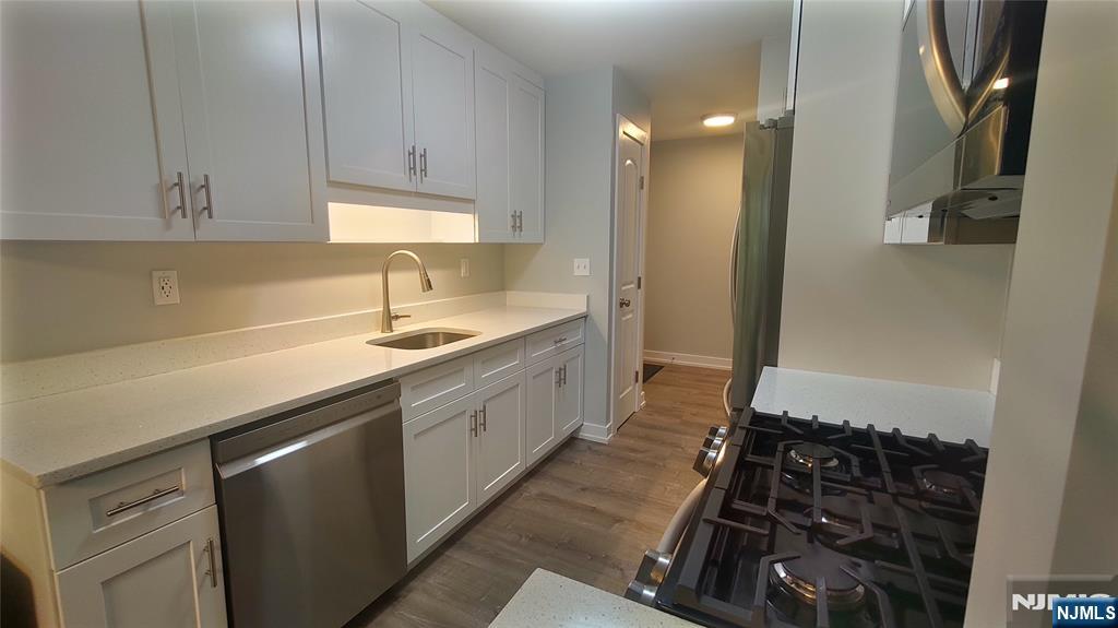 1103 Hilltop Road Mahwah, NJ 07430 - Photo 5 of 17 a bathroom with a double vanity sink a mirror and a shower