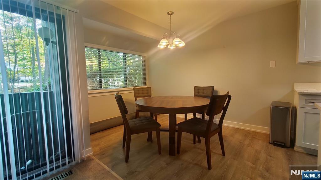 1103 Hilltop Road Mahwah, NJ 07430 - Photo 6 of 17 a view of a dining room with furniture and a chandelier
