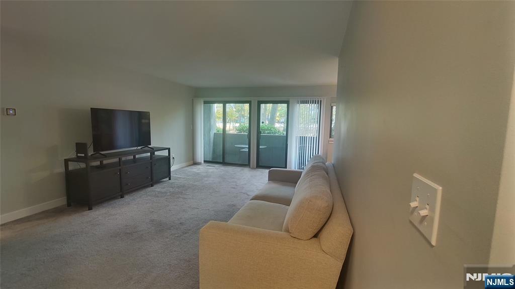 1103 Hilltop Road Mahwah, NJ 07430 - Photo 9 of 17 a living room with furniture and a flat screen tv