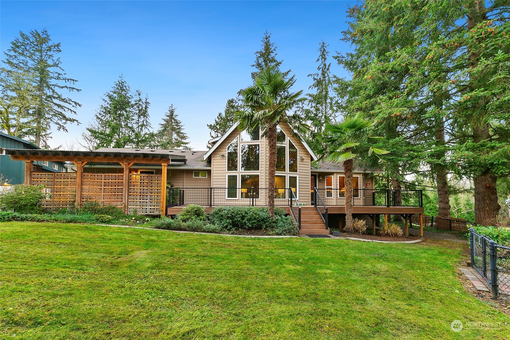 22214 Sweeney Road Southeast Maple Valley, WA 98038 - Photo 1 of 40 a front view of a house with a garden