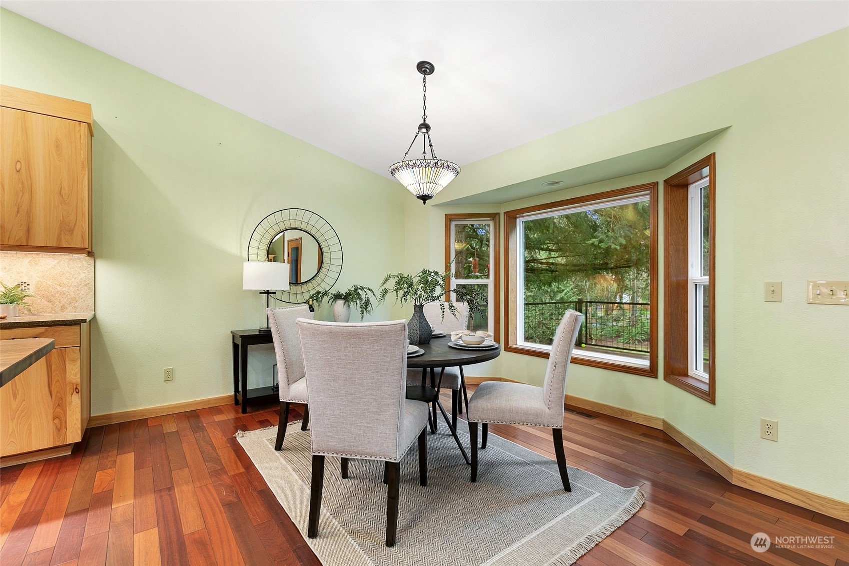 22214 Sweeney Road Southeast Maple Valley, WA 98038 - Photo 11 of 40 a dining room with furniture window and wooden floor