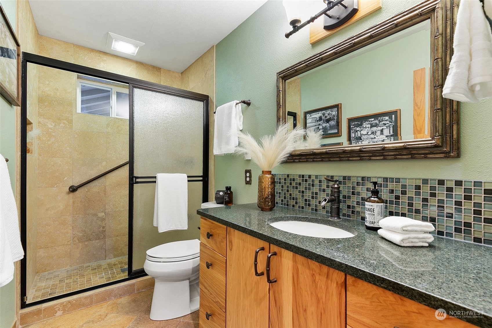 22214 Sweeney Road Southeast Maple Valley, WA 98038 - Photo 17 of 40 a bathroom with a granite countertop sink toilet and shower