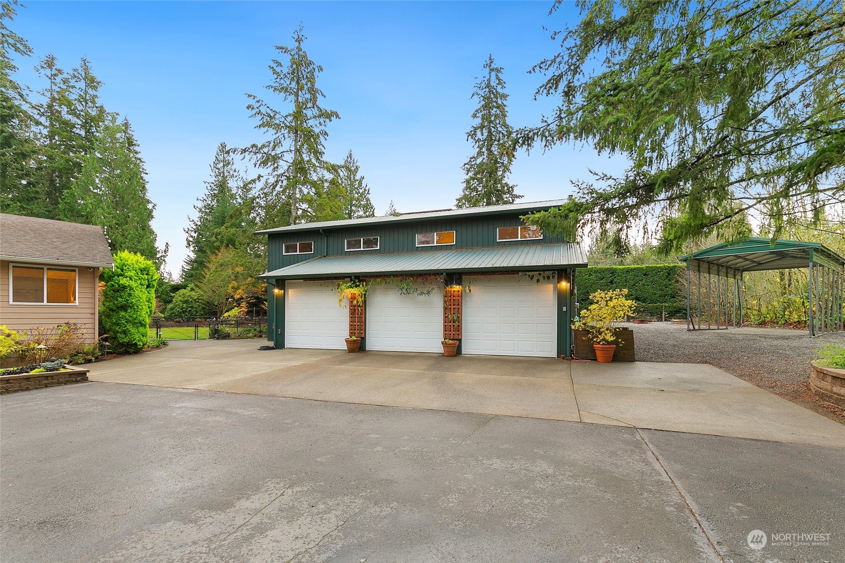 22214 Sweeney Road Southeast Maple Valley, WA 98038 - Photo 23 of 40 a house with a yard and garage