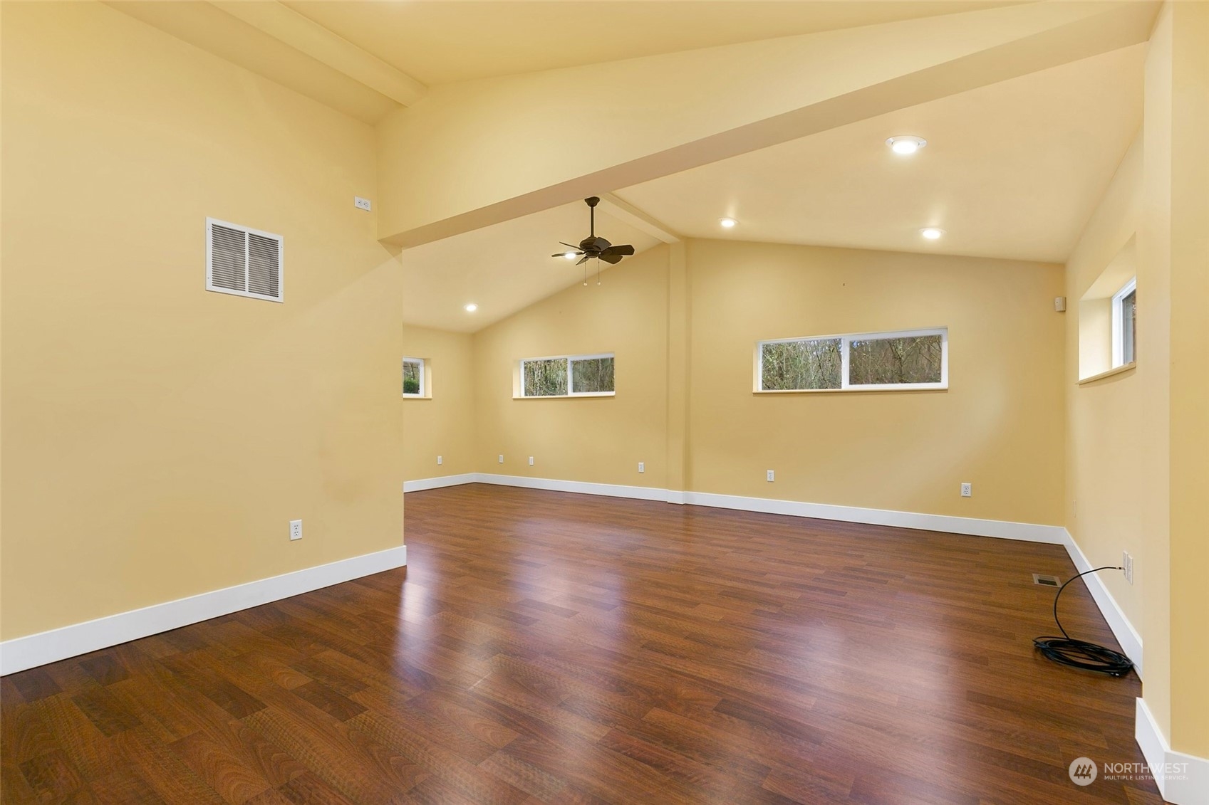 22214 Sweeney Road Southeast Maple Valley, WA 98038 - Photo 26 of 40 a view of an empty room with wooden floor and a window