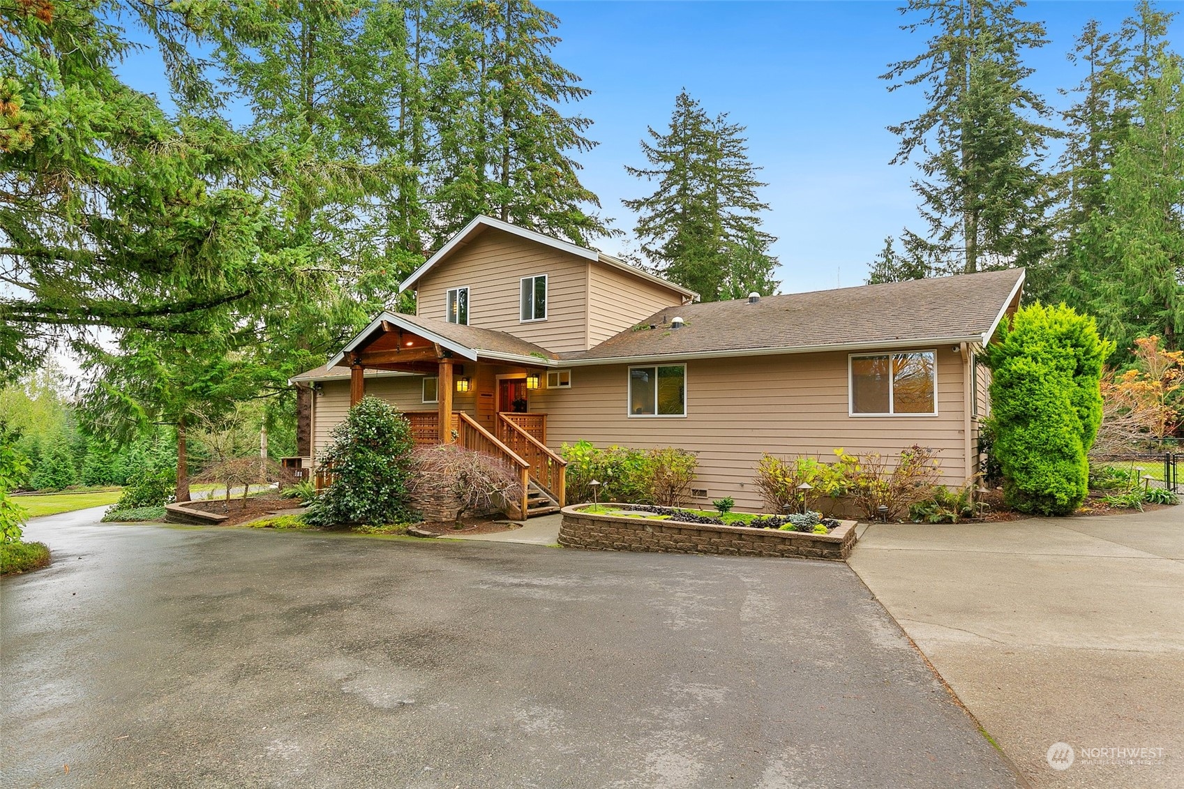22214 Sweeney Road Southeast Maple Valley, WA 98038 - Photo 38 of 40 a front view of a house with a yard and garage