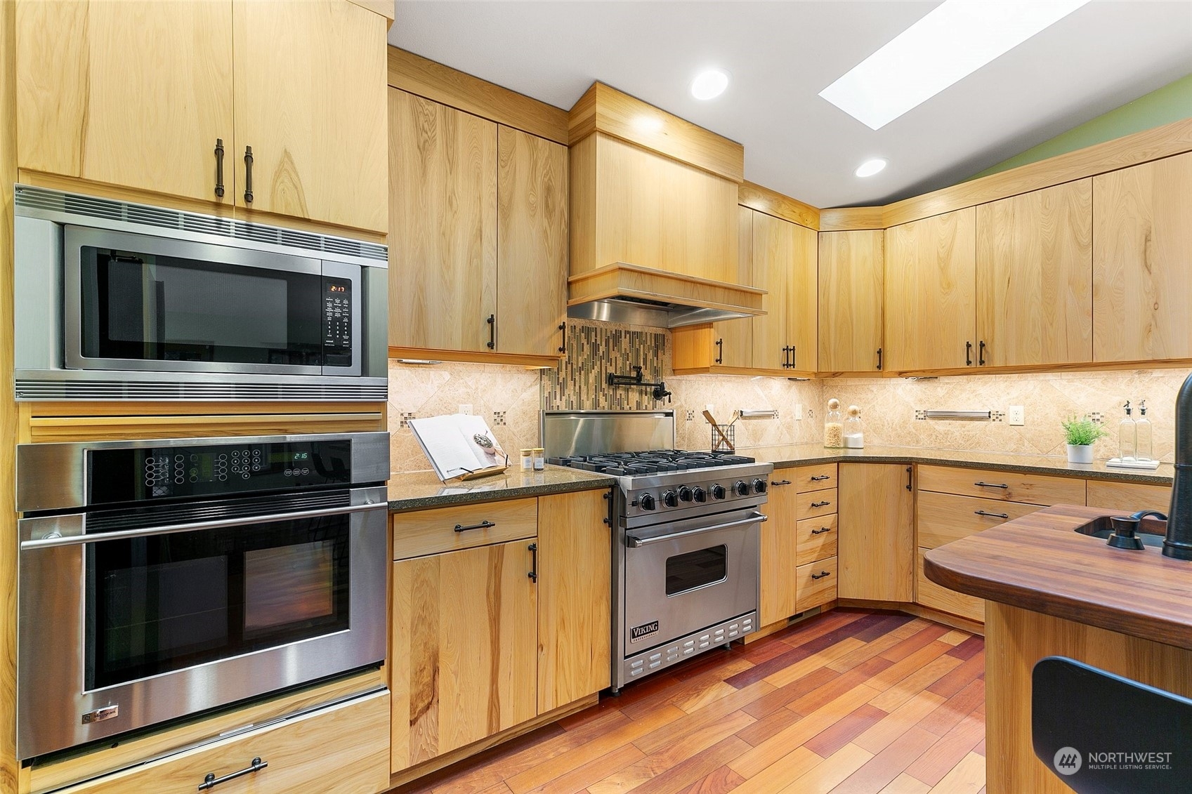 22214 Sweeney Road Southeast Maple Valley, WA 98038 - Photo 10 of 40 a kitchen with a stove and a microwave