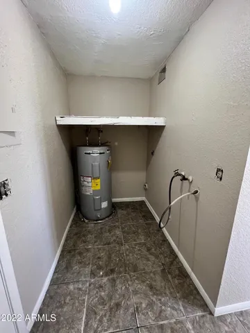 a room with a chair and white walls