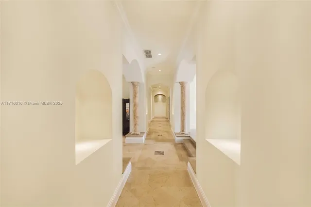 a view of a livingroom with a fireplace a ceiling fan and wooden floor