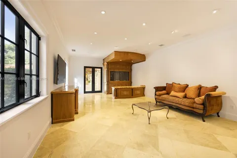 a dining room with furniture and a floor to ceiling window