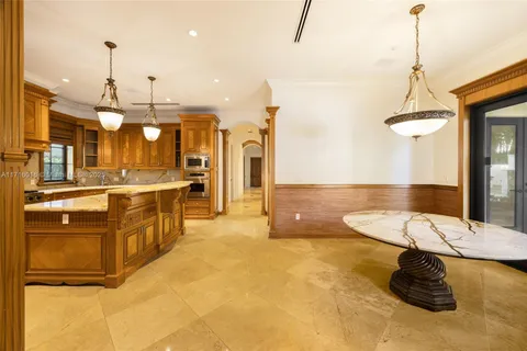 a living room filled with furniture and a floor to ceiling window