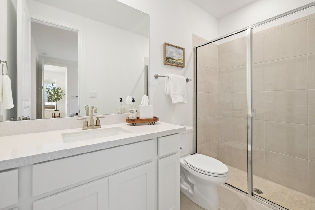 365 Pear Tree Lane Austin, TX 78737 - Photo 26 of 39 a bathroom with a sink a toilet and shower