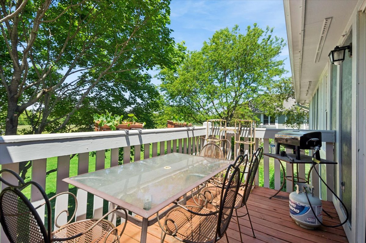 166 Hemingway Court, Unit 252 Vernon Hills, IL 60061 - Photo 10 of 18 a view of a balcony with chairs and wooden floor