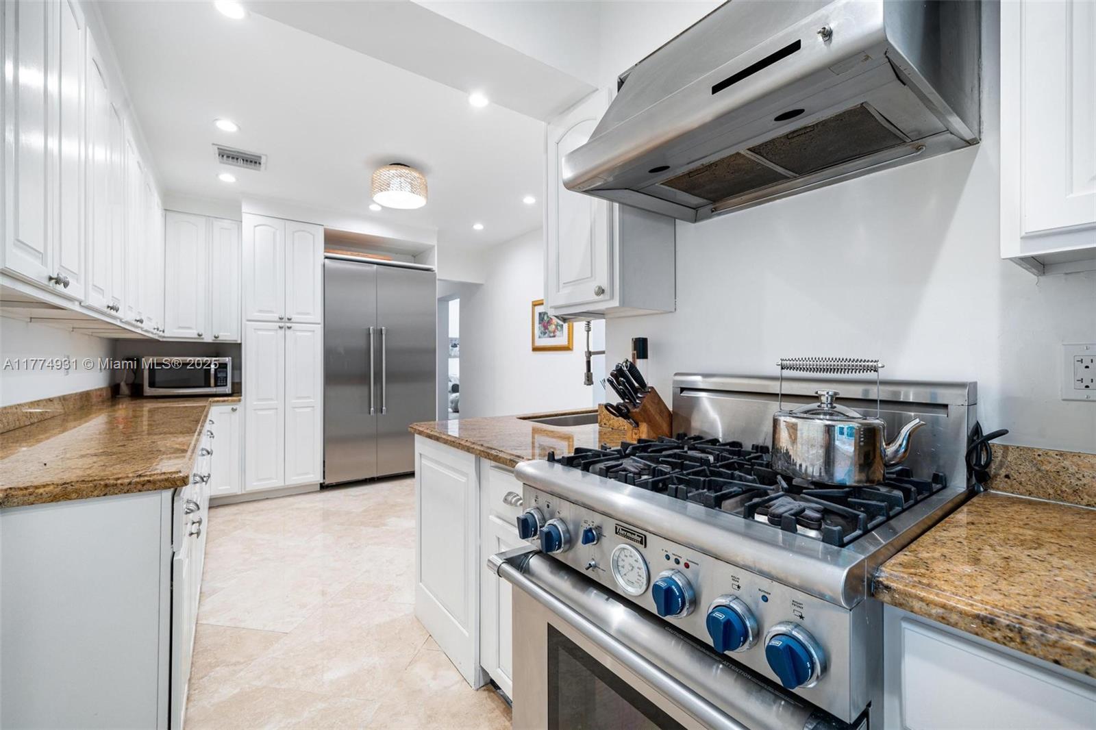 2210 Overbrook Street Miami, FL 33133 - Photo 11 of 26 a kitchen with stainless steel appliances granite countertop a stove and a refrigerator
