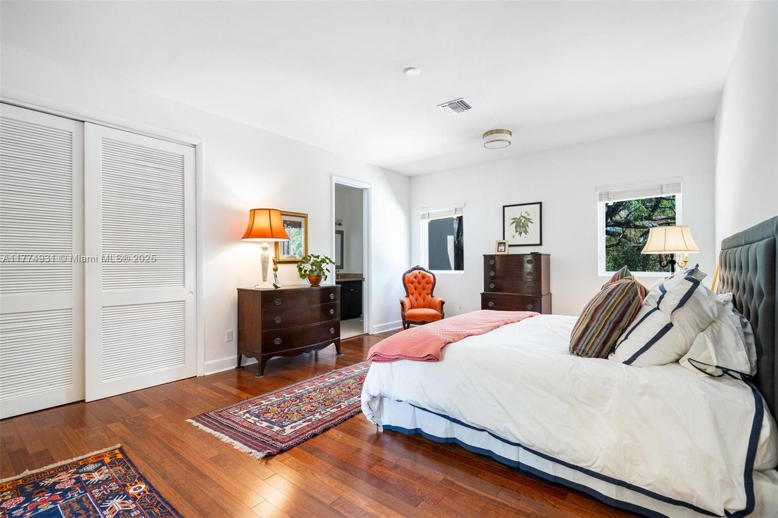 2210 Overbrook Street Miami, FL 33133 - Photo 13 of 26 a bedroom with a bed and wooden floor