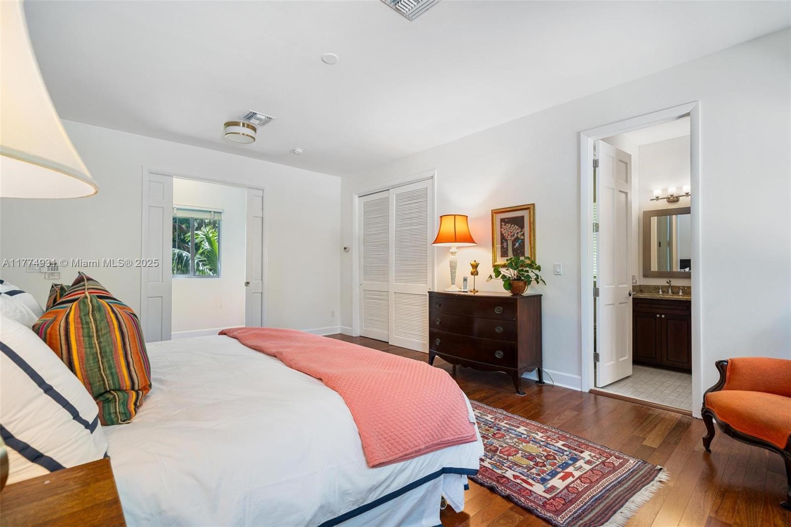 2210 Overbrook Street Miami, FL 33133 - Photo 14 of 26 a bedroom with a bed and dresser with mirror