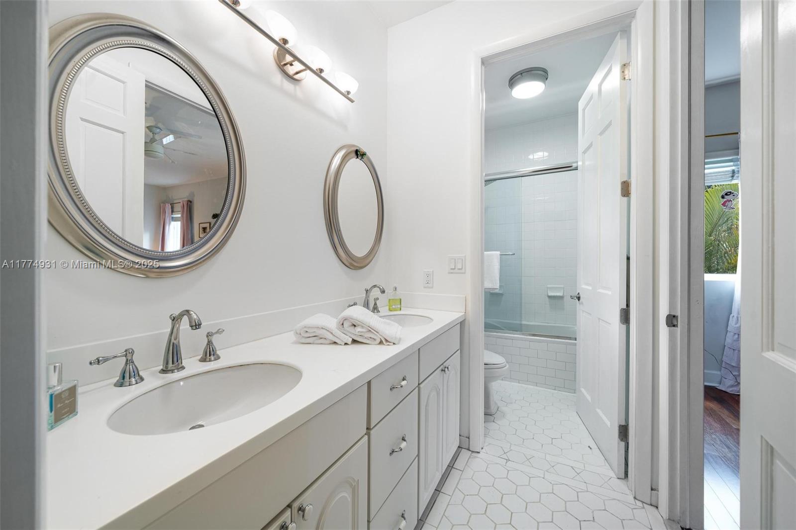 2210 Overbrook Street Miami, FL 33133 - Photo 19 of 26 a spacious bathroom with a double vanity sink and a mirror