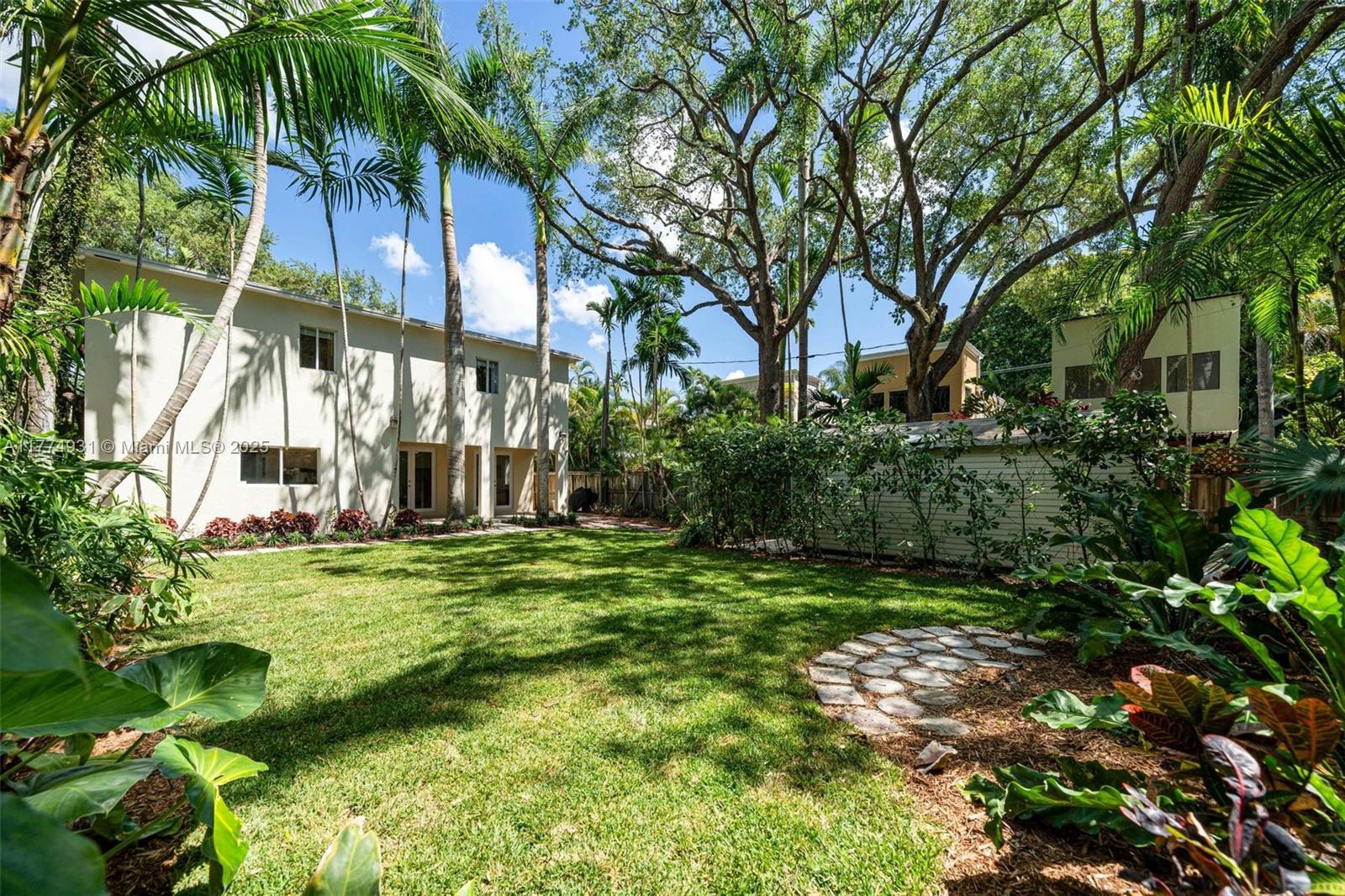 2210 Overbrook Street Miami, FL 33133 - Photo 2 of 26 a view of a big yard with plants and large trees