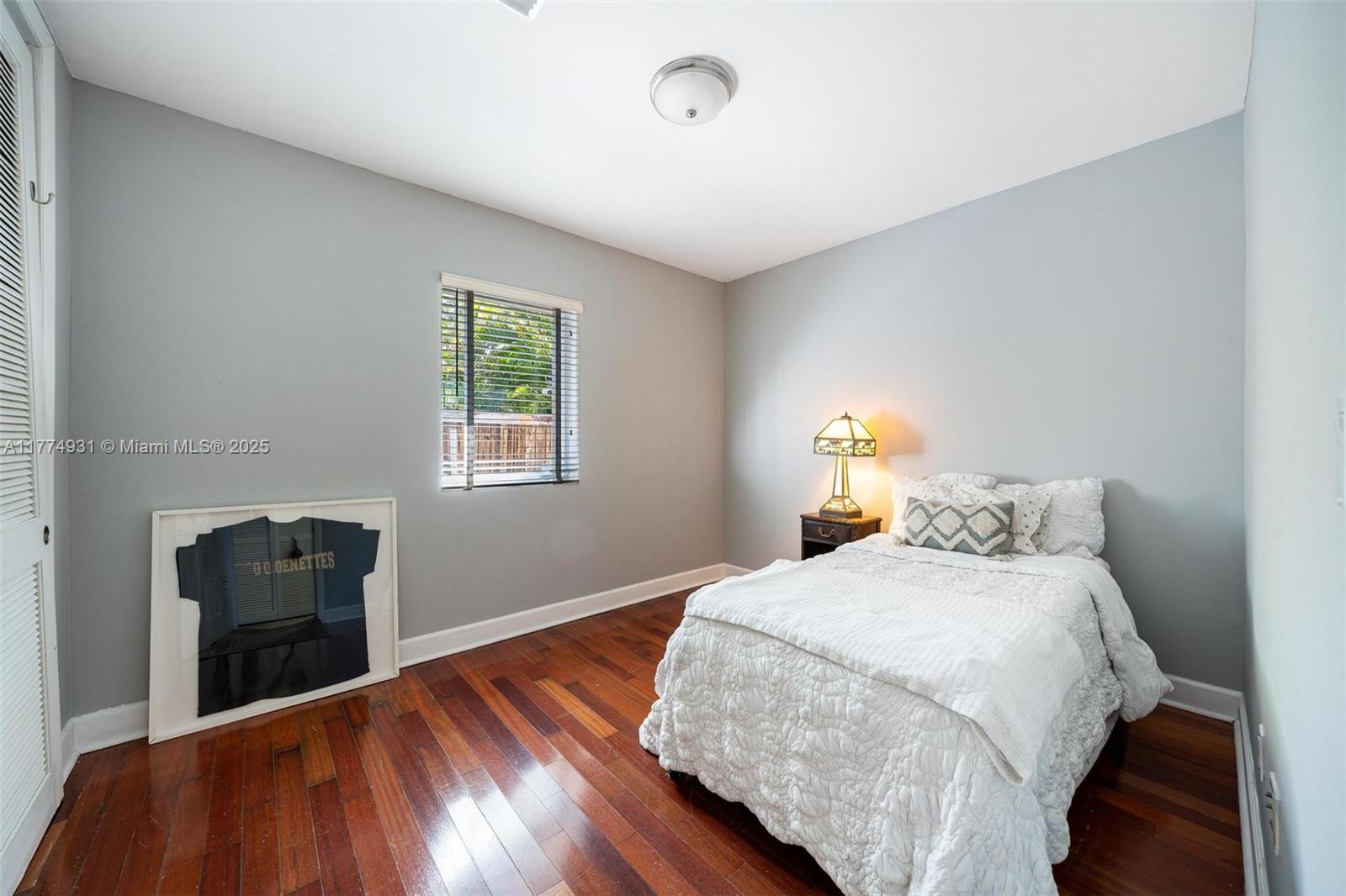 2210 Overbrook Street Miami, FL 33133 - Photo 22 of 26 a bedroom with a bed and wooden floor