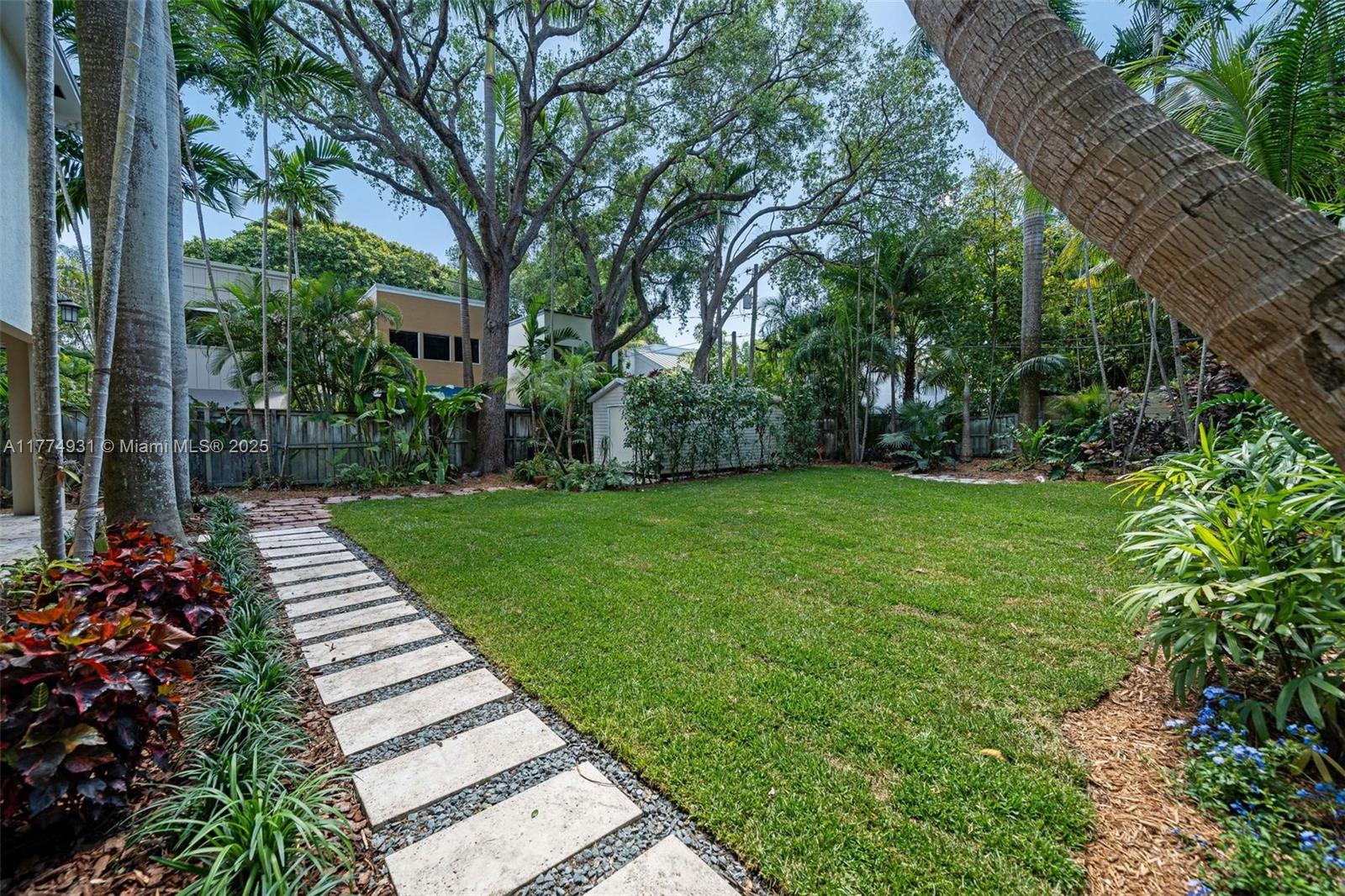 2210 Overbrook Street Miami, FL 33133 - Photo 26 of 26 a view of a garden with potted plants and large trees