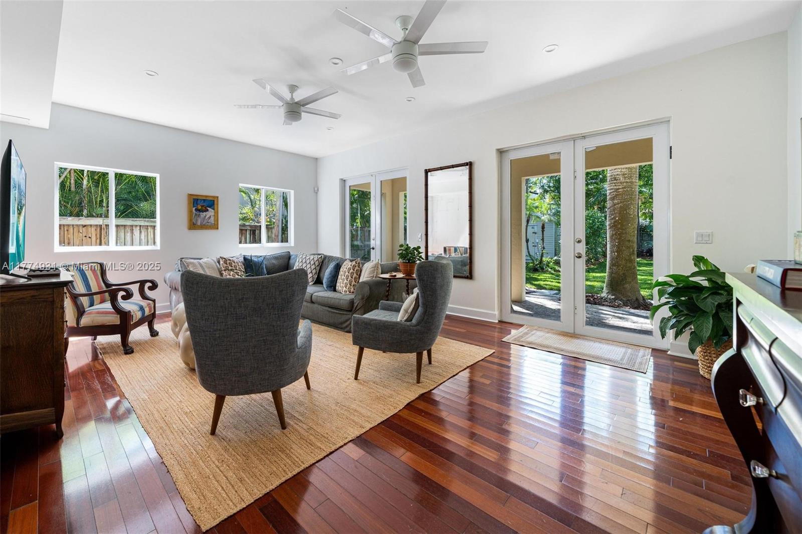 2210 Overbrook Street Miami, FL 33133 - Photo 4 of 26 a living room with furniture a wooden floor and a large window