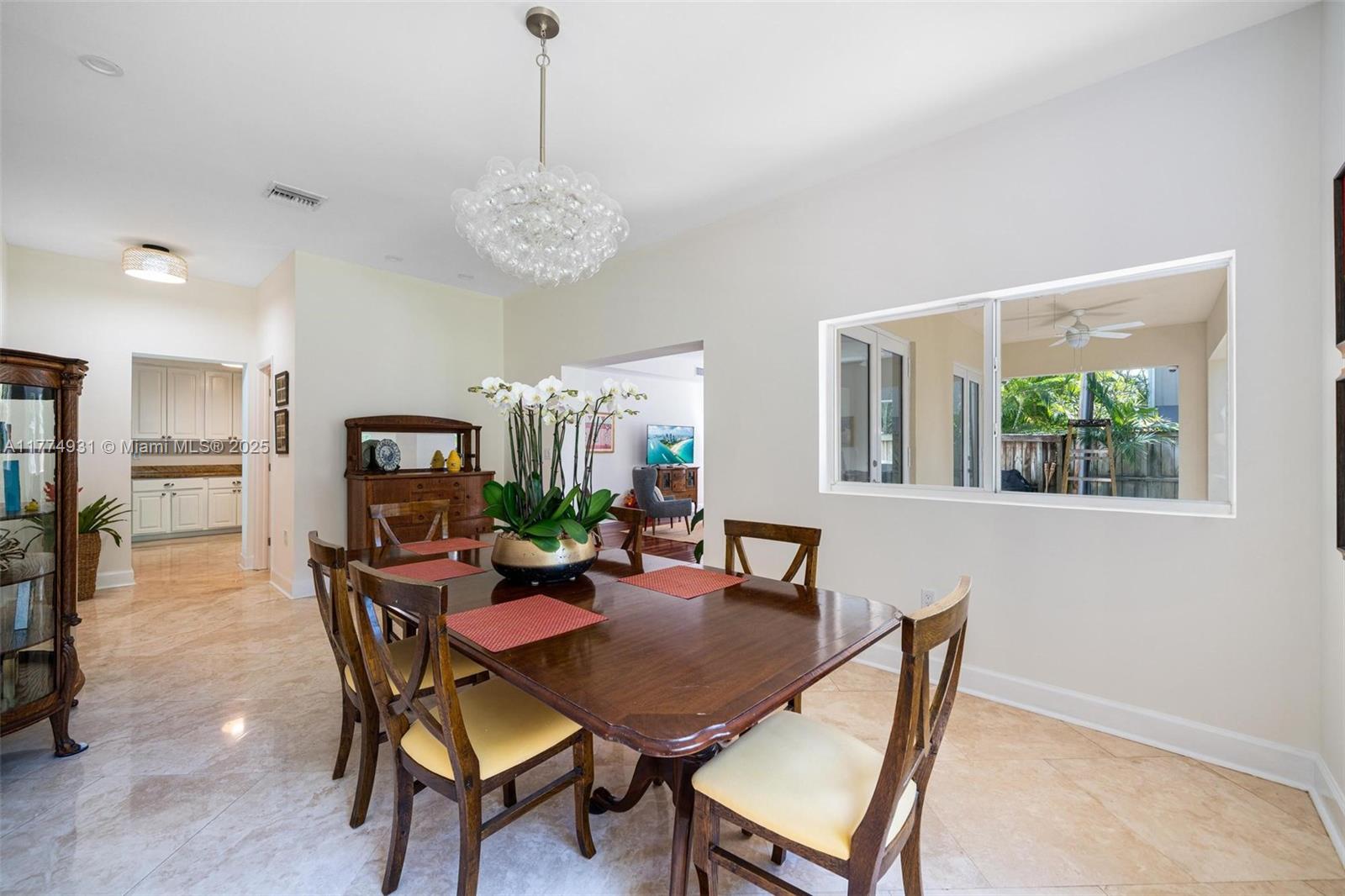 2210 Overbrook Street Miami, FL 33133 - Photo 5 of 26 a view of a dining room with furniture and a chandelier