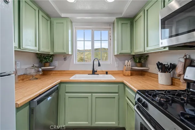 a kitchen with stainless steel appliances granite countertop a sink stove and cabinets