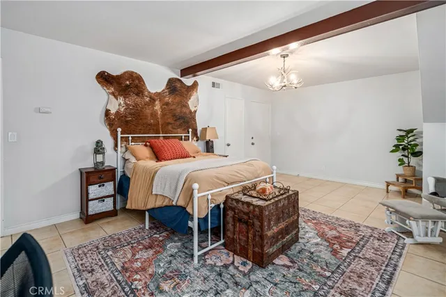 a bedroom with a bed and a potted plant