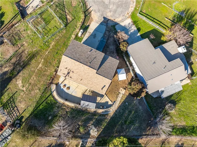 an aerial view of a house with a yard and potted plants