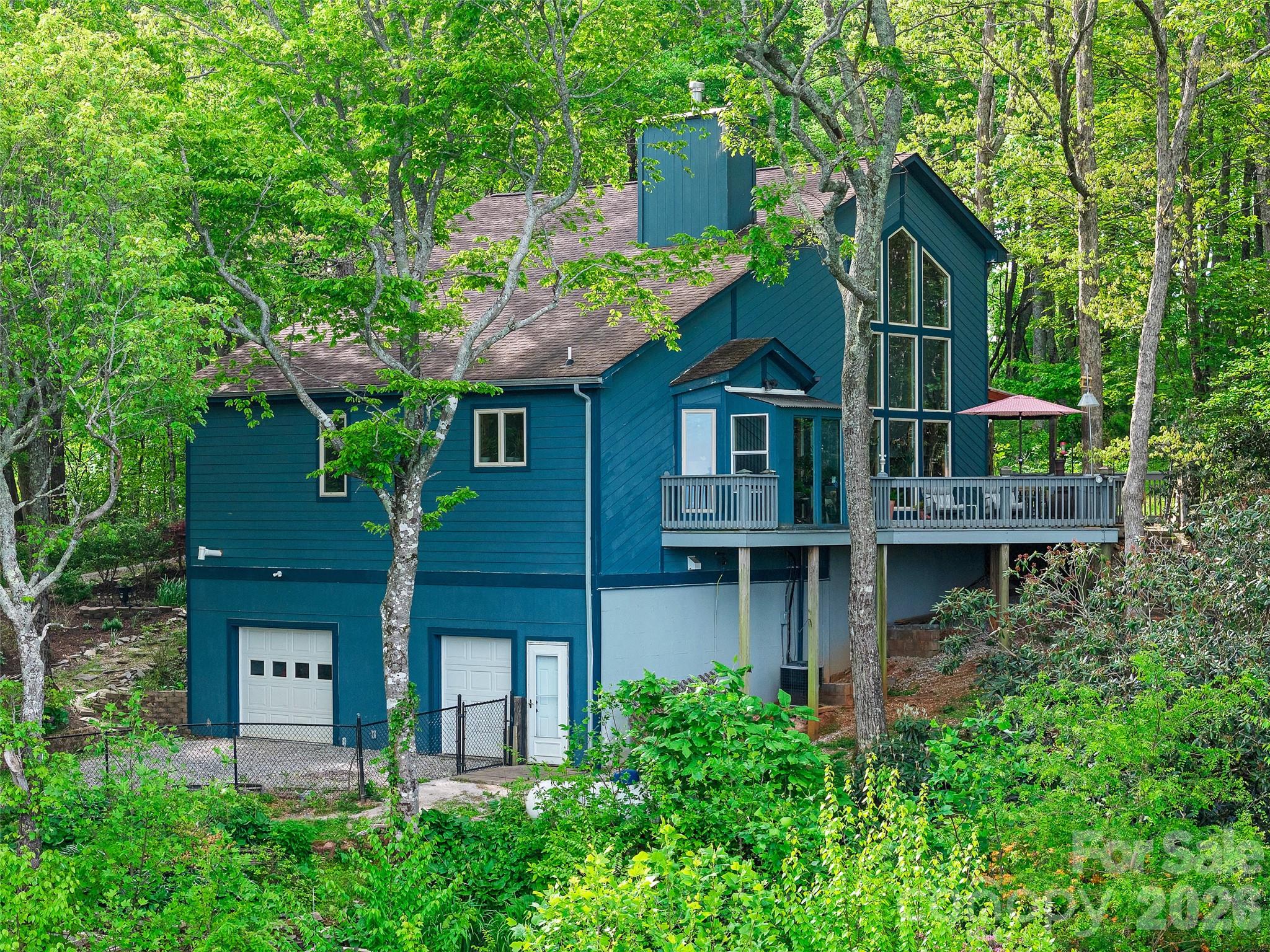 228 Continental Divide Road Spruce Pine, NC 28777 - Photo 43 of 48 front view of house with a plants and large trees