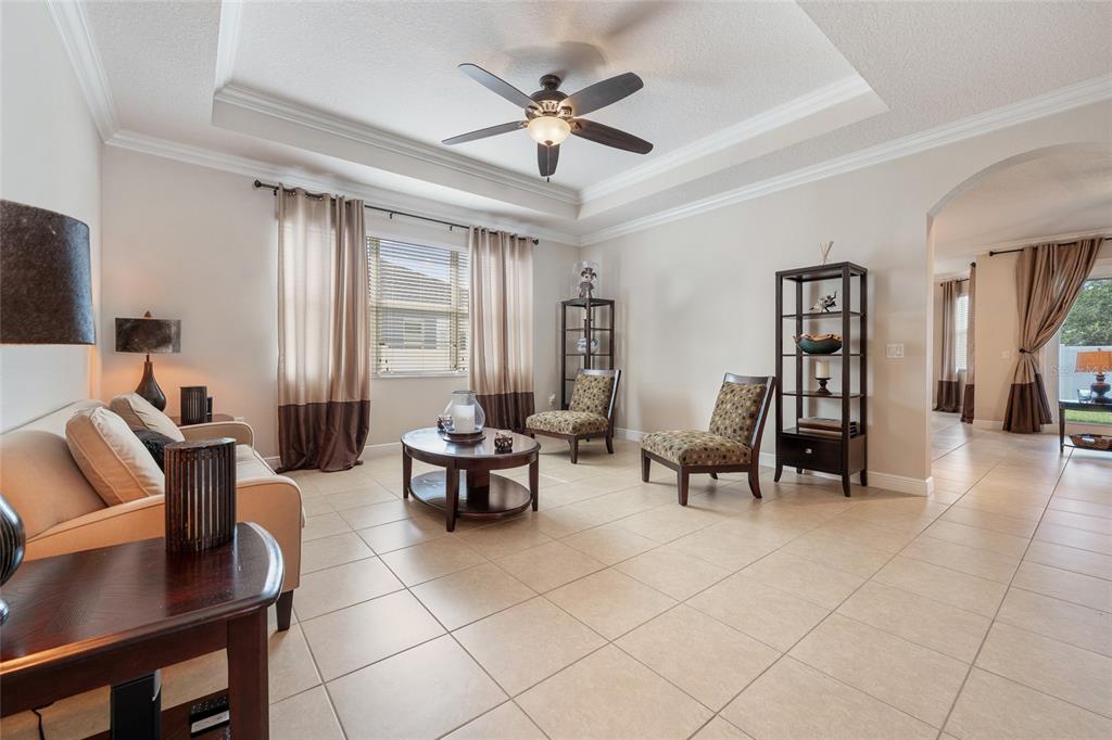 4436 Azure Isle Way Kissimmee, FL 34744 - Photo 11 of 35 a living room with furniture and a large window