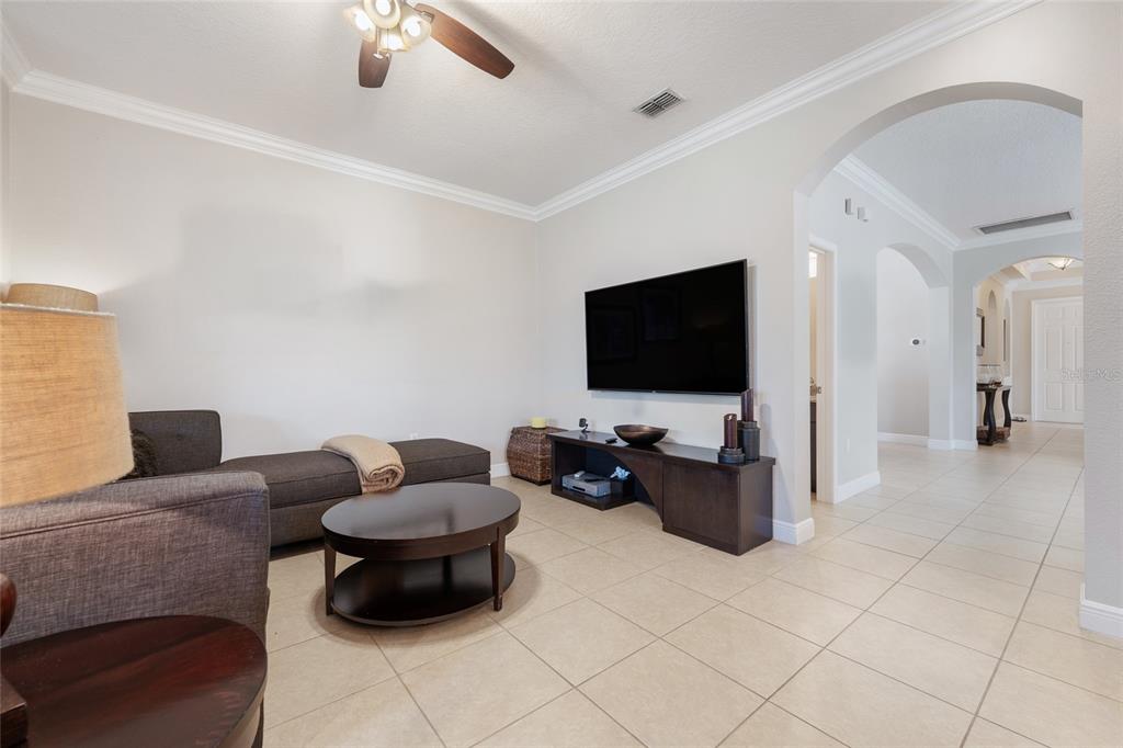 4436 Azure Isle Way Kissimmee, FL 34744 - Photo 14 of 35 a living room with furniture and a flat screen tv