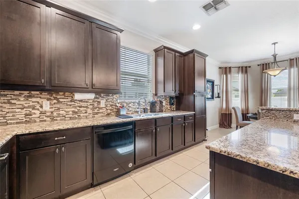 a kitchen with stainless steel appliances granite countertop wooden cabinets a sink and dishwasher