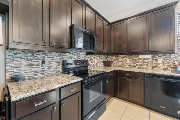 a kitchen with granite countertop cabinets stainless steel appliances and a sink counter space