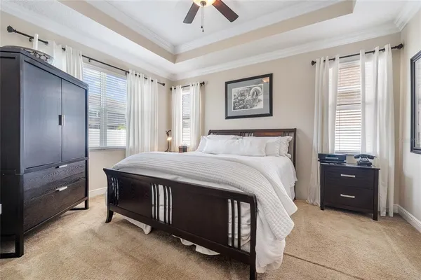 a bedroom with a bed and a chandelier